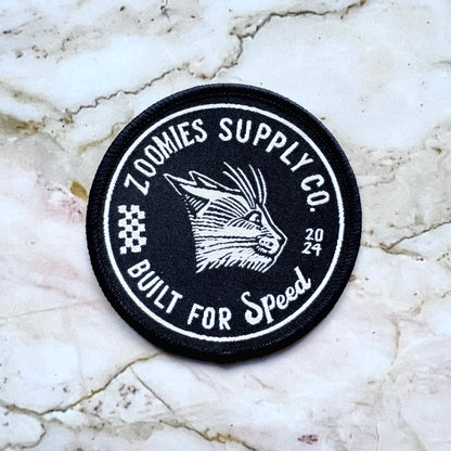Black fabric patch with a cat that has the zoomies – perfect for jackets, bags, and DIY fashion. By Jesse Jarldane
